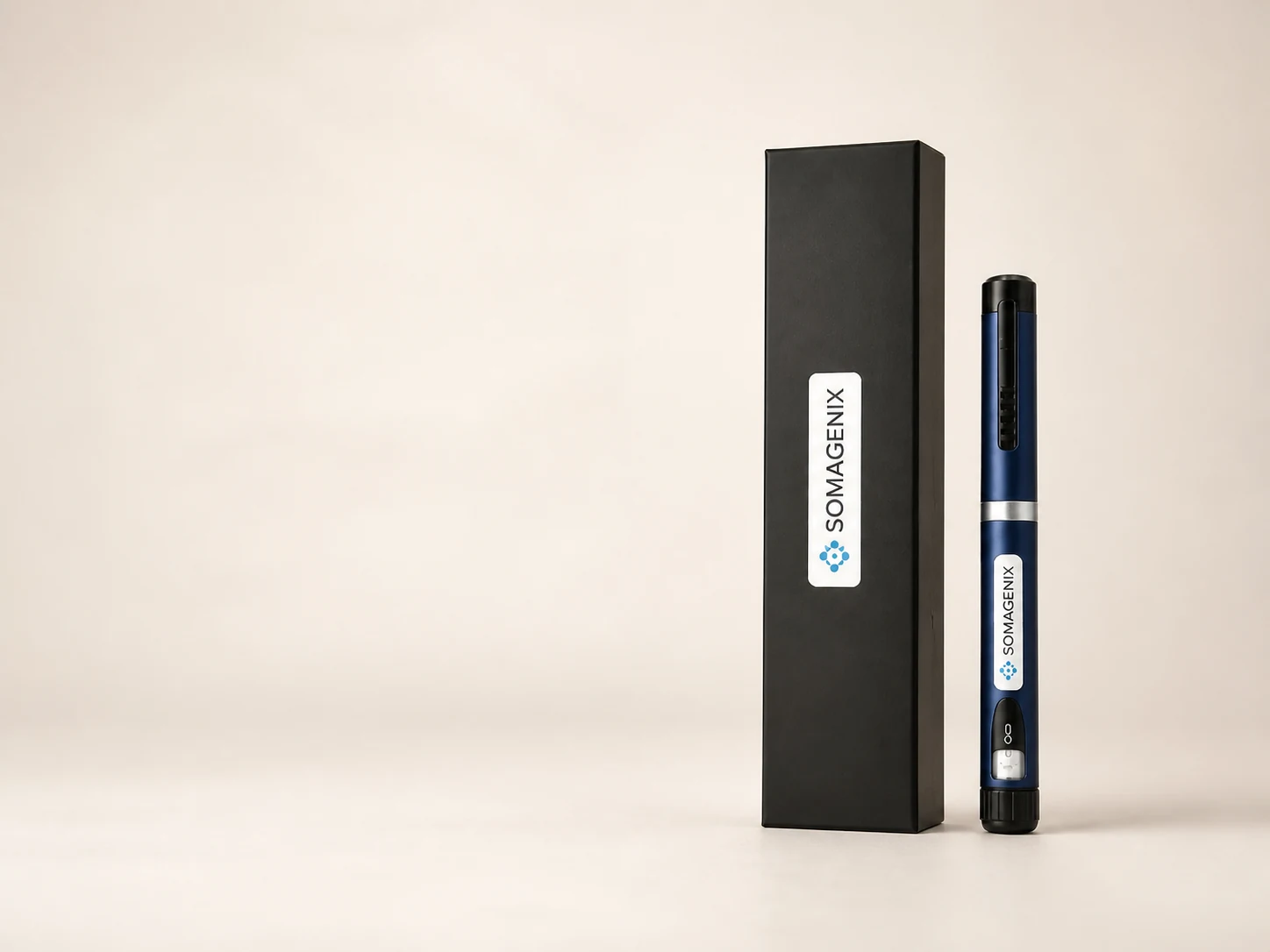 One SomaGenix navy research pen beside its matte-black presentation box